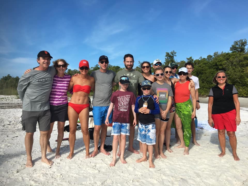A big family posing on the beach with the shells they found