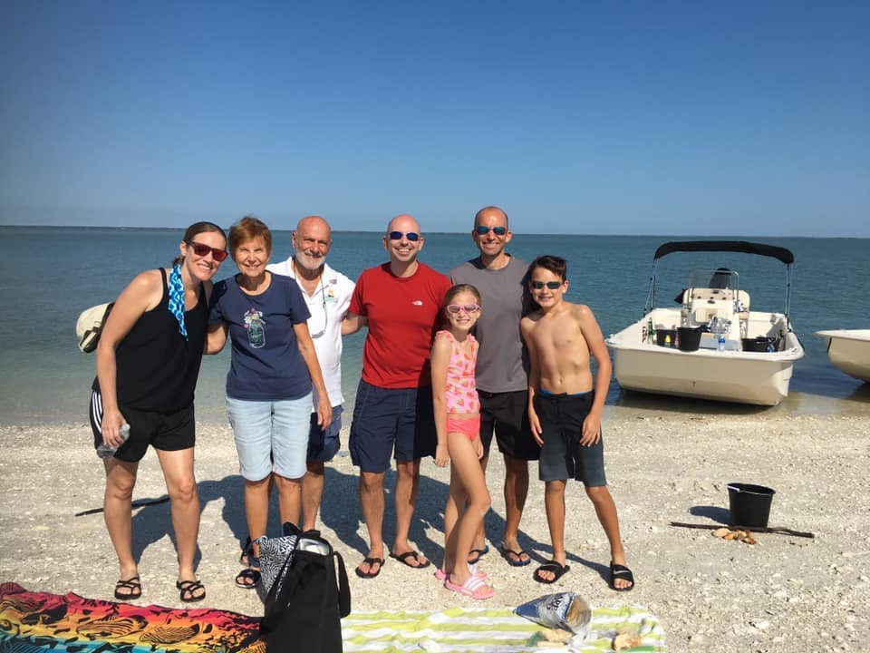 A family out shelling with their kids on a Marco Island beach