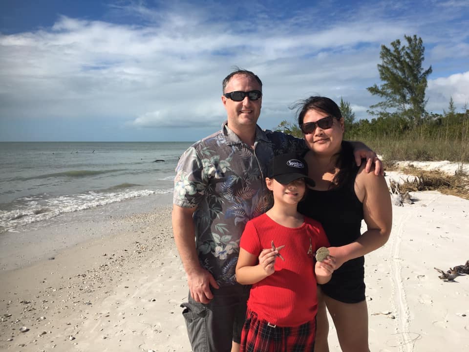 A family proudly posing with their seashells