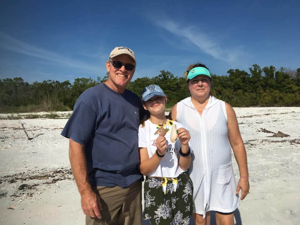 A smiling family on a Sand Dollar Shelling tour