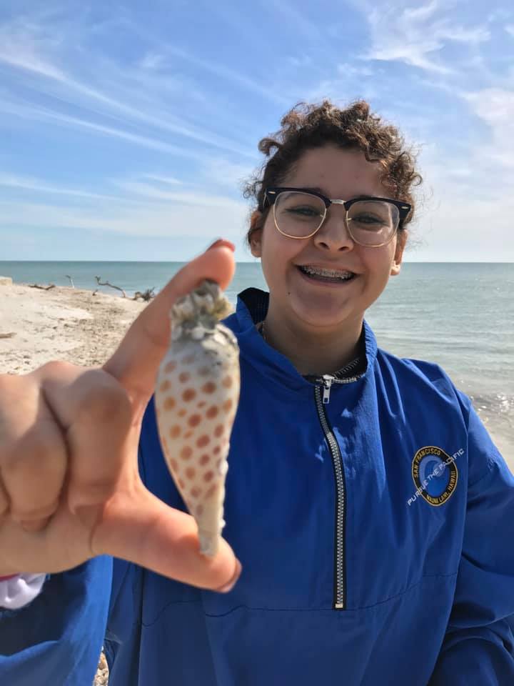 A girl beaming over the Junonia she found